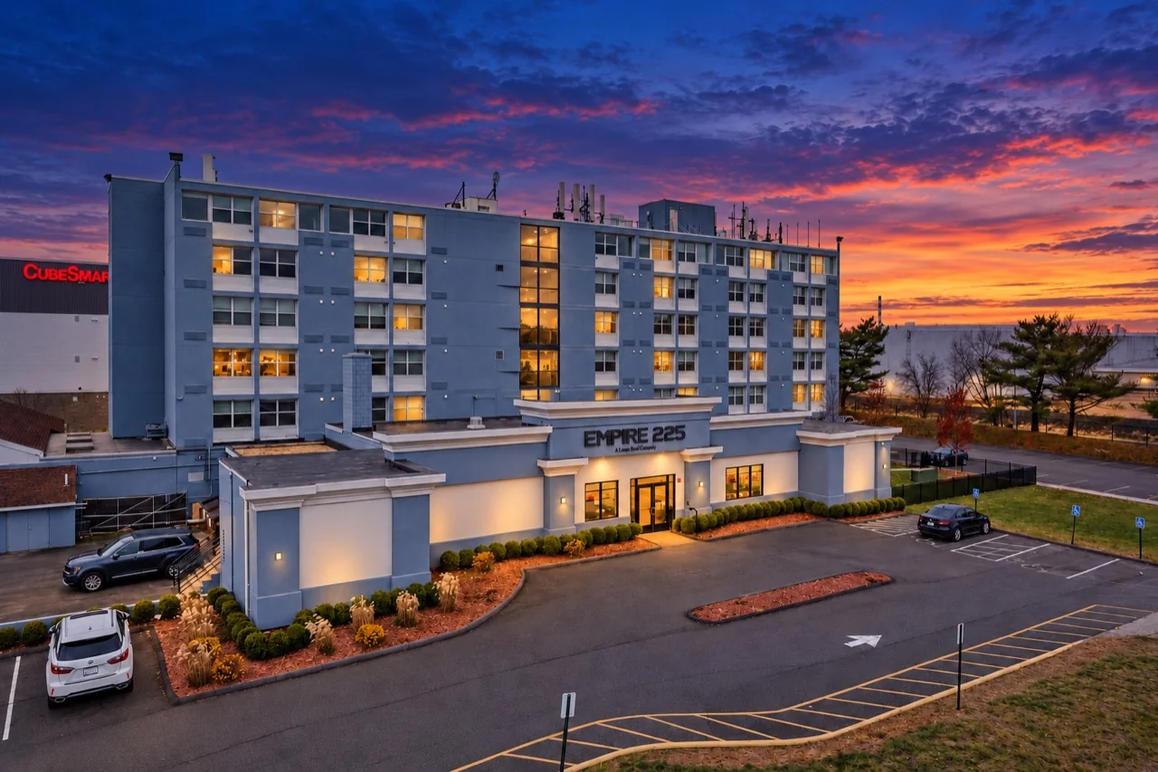 Twilight view of Empire 225 and its illuminated entrance